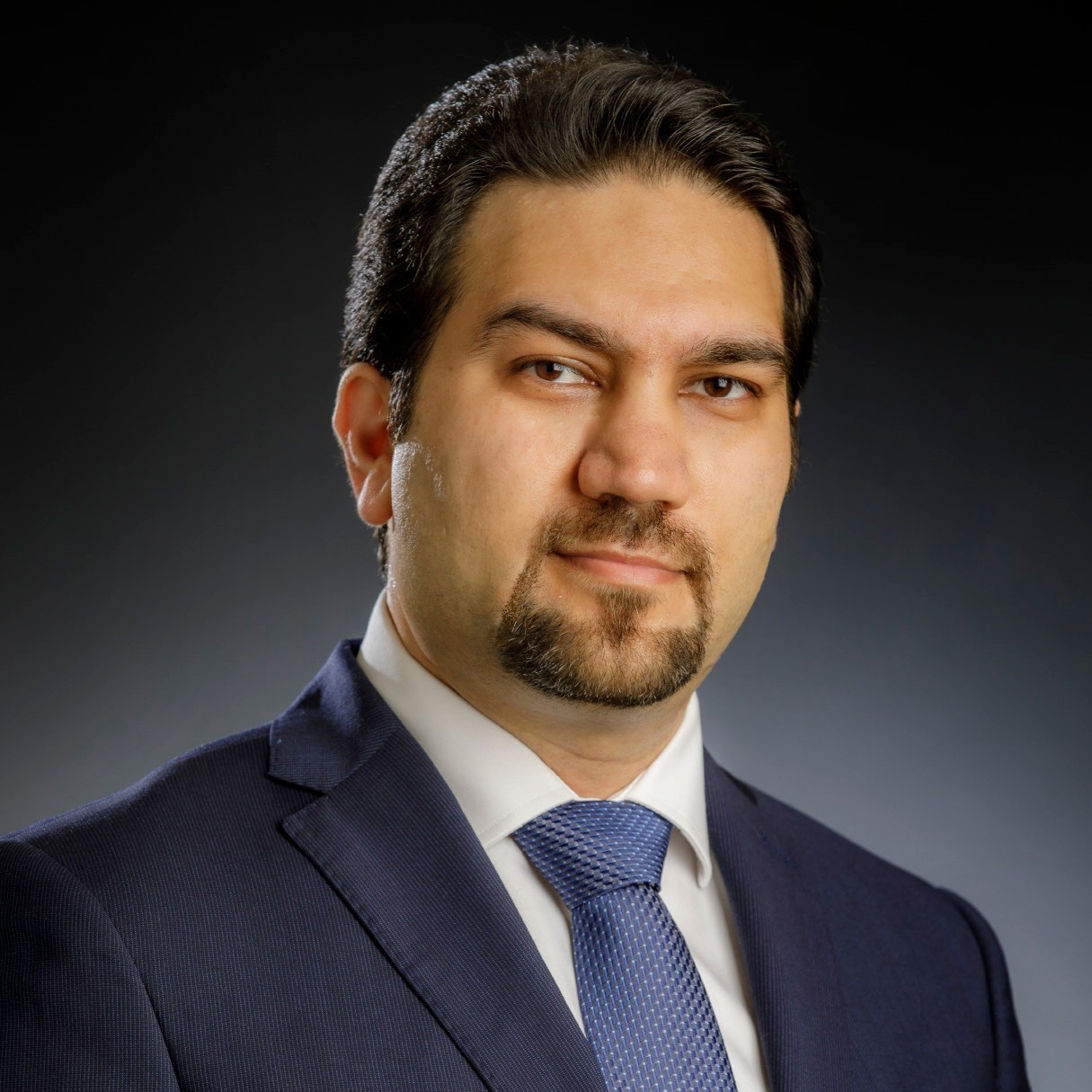 Hamid-Nazaripouya.jpg Headshot man with black hair and goatee in blue suit against back background